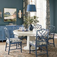 a dining room with blue walls and chairs