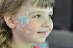 Face Paint: Elsa Snowflakes  - Suburble.com Frozen Face Paint, Elsa Makeup, Painting Snowflakes, Bodysuit Tattoos, Christmas Face Painting, Frozen Face, Elsa Costume, Face Painting Easy, Winter Face