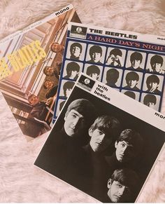 the beatles's album covers are laying on top of each other