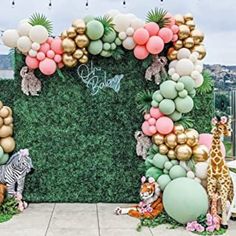 a jungle themed birthday party with balloons and giraffes