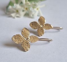 Delicate solid gold flower drop earrings, romantic jewelry earrings for women, available in 9k yellow gold, 14k yellow, white, or rose gold. Elegant handmade gold drop earrings feature each a four petals flower with a unique, organic texture. They are available in 9k yellow gold, 14k yellow, white, or rose gold.  These graceful and romantic gold earrings are excellent for everyday earrings and special occasions. Get this elegant earring set and add nature-inspired elegance to your look. Item det Delicate 14k Gold Flower Earrings For Pierced Ears, Hypoallergenic 14k Gold Flower Shaped Earrings, 14k Gold Drop Flower Earrings, Delicate Yellow Gold Pierced Flower Earrings, Hypoallergenic Yellow Gold Drop Flower Earrings, Gold Metal Drop Flower Earrings, Delicate Hypoallergenic Yellow Gold Flower Earrings, Gold Nickel-free Drop Flower Earrings, Nature-inspired Gold Flower Earrings