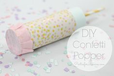 a roll of confetti paper sitting on top of sprinkles