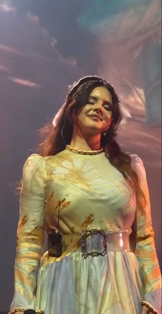 a woman with long hair wearing a white dress