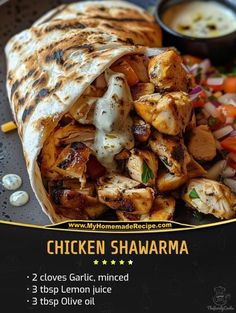 chicken shawarma on a plate with vegetables and sauce