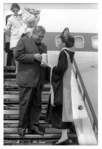 a man and woman are boarding an airplane