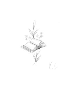 an open book sitting on top of a table next to a flower and leaf drawing