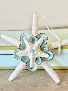 a starfish ornament is hanging on the wall