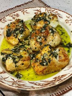 chicken with spinach and cheese in a white bowl on a tableclothed place mat