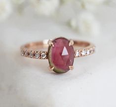 Jolene Oval Watermelon Tourmaline Ring READY TO SHIP in 14k rose gold, US size 4.75.  Details
  Main stone: Watermelon tourmaline Measurements: approx. 8x6mm Side stones: white diamonds (10) Measurements: approx. 1.2 mm Quality: clarity grade VS, color grade G, conflict-free Band size: US 4 3/4 (it can be resized)  Band width: approx. 1.6 mm
  Material: 14k rose gold  show_random_collection_products Watermelon Tourmaline Engagement Ring, Watermelon Tourmaline Ring, Gold Body Chain, Tourmaline Engagement Ring, Flawless Diamond, Gold Bodies, Dream Engagement, Dream Engagement Rings, Ring Pictures