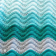 a crocheted blanket with waves on it