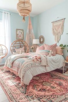 a bedroom with blue walls and pink bedding, hanging hammock chair, rugs on the floor