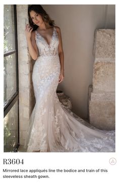 a woman in a wedding dress standing next to a window