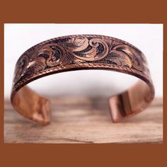 Ships in 5 to 7 business days 5/8" width x 6" length  Brian has crafted this lovely copper cuff with precision from solid copper sheet, and engraved it with an intricate scrollwork design and border by hand. This stunning copper bracelet is a perfect blend of elegance and sophistication. The combination of the warm, earthy tones of the copper and the detailed scrollwork creates a mesmerizing visual appeal that will catch everyone's eye. Its versatility allows it to effortlessly complement any ou Scrollwork Design, Cowboy Copper, Rodeo Jewelry, Clear Nail Polish, Copper Sheets, Copper Cuff, Jewelry Statement, Western Jewelry, Copper Bracelet