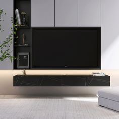 a living room with a couch, television and bookcase on the wall in front of it