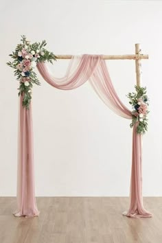 an arch decorated with flowers and greenery for a wedding ceremony or special occasion in pink