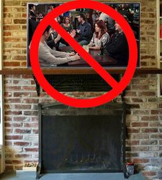 a tv with a no sign over it in front of a brick fireplace