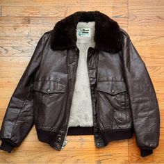 Size 42. Vintage 1980s A2 Flight Jacket. Pristine Sherpa Lining With A Puffy Shearling Collar. The Brown Leather Is Well-Kept And Conditioned With Some Natural Creasing/Aging/Scuffs As Pictured. This Piece Is Classic, Rugged, Timeless. An Absolute Essential. Vintage Leather Jacket With Faux Fur Lining For Winter, Retro Brown Outerwear With Faux Fur Lining, Retro Brown Leather Jacket For Winter, Retro Leather Winter Outerwear, Vintage Brown Retro Leather Jacket For Winter, Retro Leather Outerwear For Winter, Winter Vintage Brown Biker Jacket With Pockets, Fitted Vintage Brown Leather Winter Jacket, Fitted Vintage Brown Leather Jacket For Winter