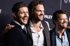 three men standing next to each other on a red carpet with the words paley written on it