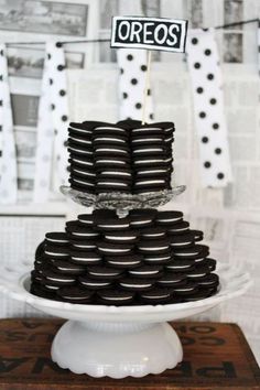 a stack of cookies sitting on top of a white cake plate