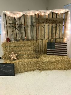 hay bales are stacked on top of each other in front of a backdrop with stars and lights