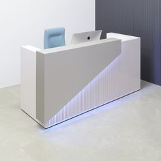 a white reception desk with a blue chair next to it and a wall in the background