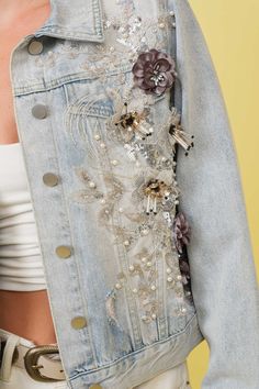 Light blue flower embellished jean jacket. This jacket is the perfect blend of style and fun. The light blue color is perfect for any outfit (whether you're serious about fashion or not). Plus, the delicate flower embellishments add a unique touch that you won't find anywhere else. Bring some floral fun to your wardrobe with this jean jacket! Spring Light Wash Denim Jacket, Trendy Floral Embroidered Denim Jacket For Spring, Light Wash Denim Jacket For Spring, Spring Party Denim Jacket, Spring Party Outerwear With Floral Embroidery, Fitted Denim Jacket For Spring Parties, Party Denim Jacket Embellished, Trendy Light Blue Denim Jacket For Spring, Spring Denim Embellished Outerwear