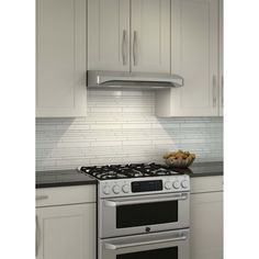 a kitchen with white cabinets and stainless steel stove top, oven hood over the range