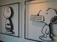 two framed pictures with cartoon characters on them, each depicting a person and a dog