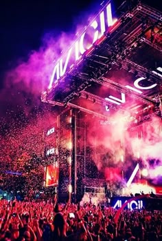 a large crowd at a concert in front of a stage