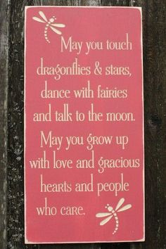 a sign on a wooden fence that says may you touch dragonflies & stars, dance with fairies and talk to the moon