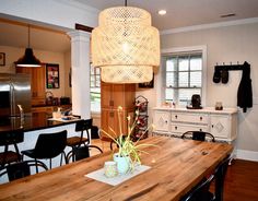 a wooden table sitting in the middle of a kitchen