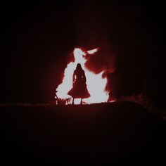 a person standing in front of a fire