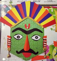 a green mask with red, yellow, and blue designs on it