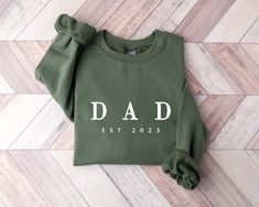 Custom Dad Est 2023 Sweatshirt and Hoodie, Custom Date Sweatshirt, Fathers Day, Gift for Daddy, Dada Sweatshirt, Papa Crewneck, Gift for Him   🌿WELCOME TO UNIQUE TRENDS DESIGN  If you are looking for soft, comfy, first-rate sweatshirts, you're in the right place! Here at Top Creative Designs, we love what we do and strive to make your shopping experience just right for you. If you have any questions, concerns, or comments about our products, feel free to shoot us a message anytime. Even on weekends and holidays, we'll try our best to respond as quickly as possible! Product Details Unisex Sweatshirts: - Gildan Brand -50% cotton - Light/medium weight and soft, this sweatshirt is sure to be your next favorite sweatshirt. 🌿Sizing and Coloring Please make sure you select the right color and s Christmas Letters, Christmas Crewneck, Merry Christmas Shirts, Women Christmas, Sweatshirt Christmas, Holiday Sweater, Look Plus, Christmas Women, Christmas Shirt