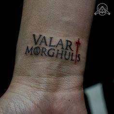 a wrist tattoo with the word valar morghuls on it