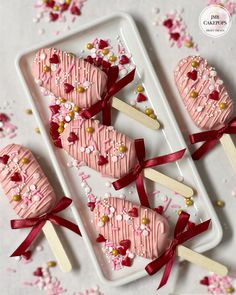 valentine's day desserts are arranged on trays