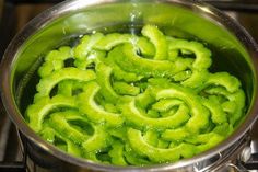 a pot filled with green sauce on top of a stove