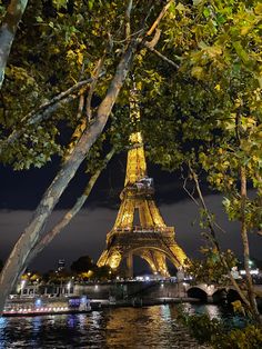 the eiffel tower is lit up at night