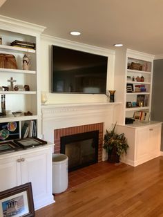 a living room filled with furniture and a flat screen tv mounted above a fire place