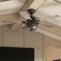 a ceiling fan that is hanging from the ceiling in a room with wood beams and white walls