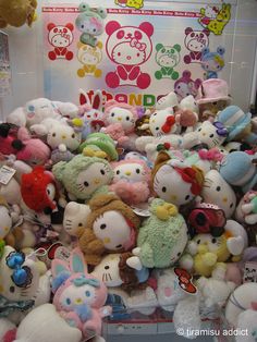 a pile of hello kitty stuffed animals on display