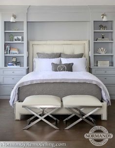 a white bed sitting in a bedroom on top of a hard wood floor