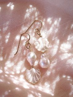 These asymmetrical carved Seashell and Baroque Pearl Earrings make beautiful simple statements. Seemingly plucked straight from the ocean, the luminous, organic white pearls sway and illuminate in the light. Wear these unique pearl, shell, and gold earrings for a modern upgrade.✦ DETAILS ✦✧ Name: Momi - (MOH mee) - pearl.✧ 14kt Gold Filled.✧ Genuine Freshwater Baroque Pearls.✧ Carved Mother of Pearl Seashells.✧ All Ke Aloha Jewelry pieces come packaged thoughtfully, beautifully, and ready for gi Elegant Shell Pearl Earrings, Ocean-inspired Shell Pearl Earrings For Gift, Handmade Pearl Shell-shaped Earrings, Ocean-inspired Shell-shaped Pearl Earrings, Earrings Gold Pearl, Gold Pearl Shell-shaped Earrings, Seashell Earrings, Baroque Pearl Earrings, Gold Pearl Earrings