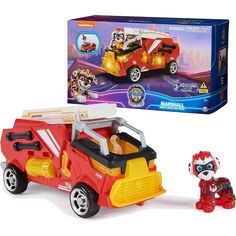 a toy fire truck with a dog next to it