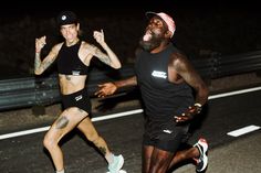 two people running in the street at night with one person showing off his muscles and the other