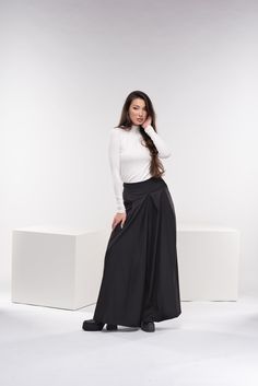 "Absolutely gorgeous wide-leg palazzo pants with a zipper on the back as closure, and two side functional deep pockets for your comfort. These wool trousers have that gorgeous, inspiring, breathtaking, chic, classic but still modern look. The fabric is super soft high-quality cold wool fabric. You can find the short version here: https://www.etsy.com/listing/1298365794/wool-wide-leg-pants-palazzo-skirt-pants?ref=listings_manager_grid ◼ FIT These palazzo skirt pants are of regular fit. To have the same look as on our model, please check our body measurements size chart below, especially the waist measurement, and choose the correct size for you. ◾The model in the picture is wearing size XS in black color. ◼ FABRIC ◾cold wool mix fabric ◼ INFO: ◾ Worldwide express shipping - please provide a Black Loose Fit Wide Leg Maxi Skirt, Black Wide-leg Maxi Skirt, Baggy Wide Leg Maxi Skirt For Fall, Elegant Stretch Wide Leg Maxi Skirt, Wide Leg Stretch Skirt, Stretch Wide Leg Skirt, Wide Leg Black Maxi Skirt For Work, Black Stretch Wide Leg Maxi Skirt, Black Stretch Wide Leg Culottes