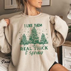 "I like them real thick and sprucy, Women's Christmas gift, funny Christmas gift, holiday shirts, Christmas Sweatshirt, Retro Christmas Shirt Ideal for any situation, a unisex heavy blend crewneck sweatshirt is pure comfort. These garments are made from polyester and cotton. This combination helps designs come out looking fresh and beautiful. The collar is ribbed knit, so it retains its shape even after washing. There are no itchy side seams on these sweaters.  .: Made with a medium-heavy fabric blend of 50% cotton and 50% polyester (8.0 oz/yd² (271.25 g/m this sweatshirt feels cozy and is the perfect choice for those colder months. .: The classic fit along with the crew neckline deliver a comfy wearing experience with a clean-cut style. Meanwhile, the double-needle stitching at the should Funny Winter Top With Text, Winter Funny Style Top With Text, Winter Funny Text Top, Winter Cotton Tops With Funny Text, Funny Cotton Tops For Winter, Winter Tops With Funny Print, Cute Christmas Shirts, Funny Christmas Gifts, Holiday Sweatshirt