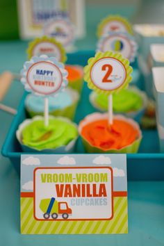 there are cupcakes on the table with name tags for each one and two