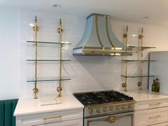 a stove top oven sitting inside of a kitchen next to white counter tops and cabinets