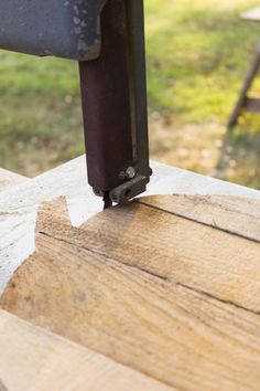 a piece of wood that is sitting on top of a table with a tool in it